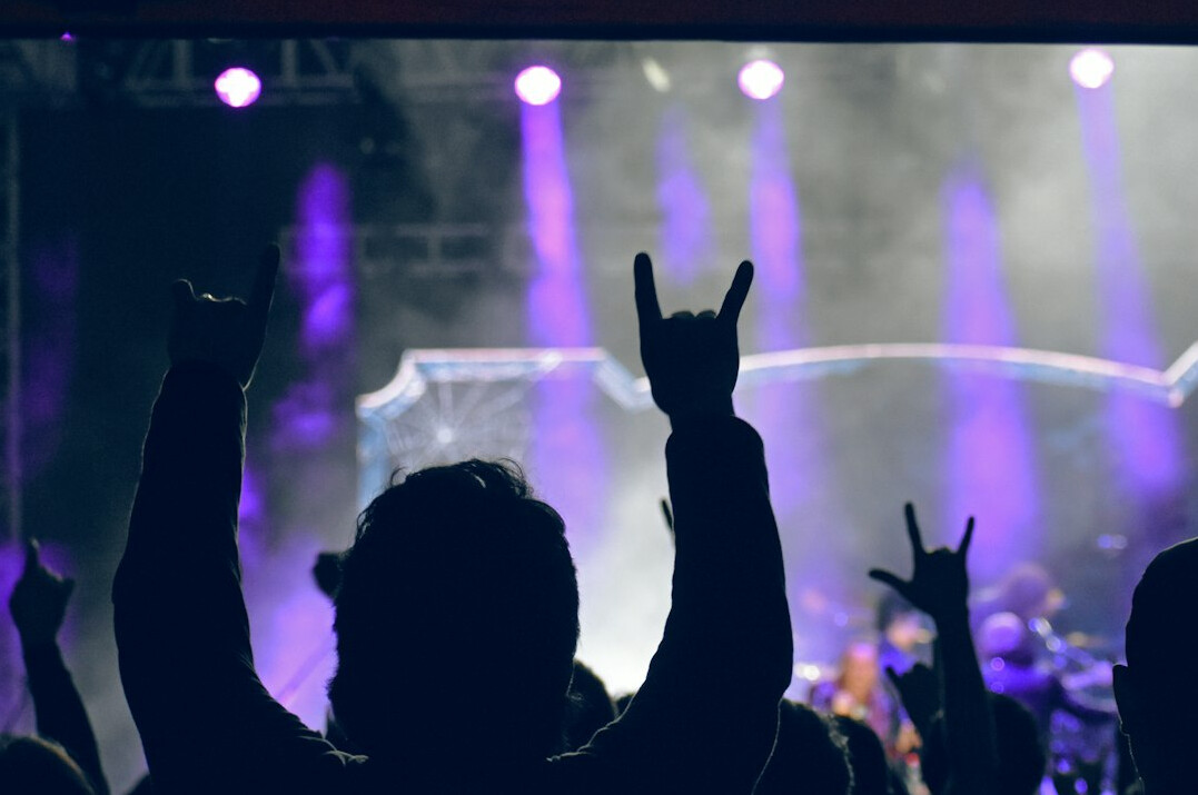 Crowd at a live music concert with stage lights
