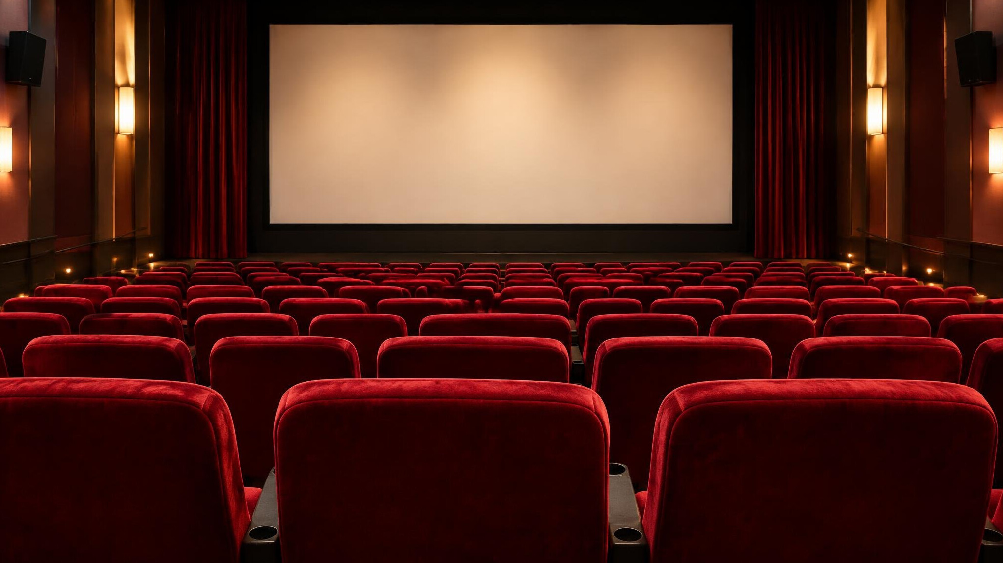 Empty cinema seats facing a screen